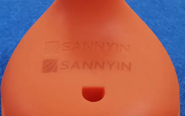 Laser engraved LOGO on an orange silicone rubber product