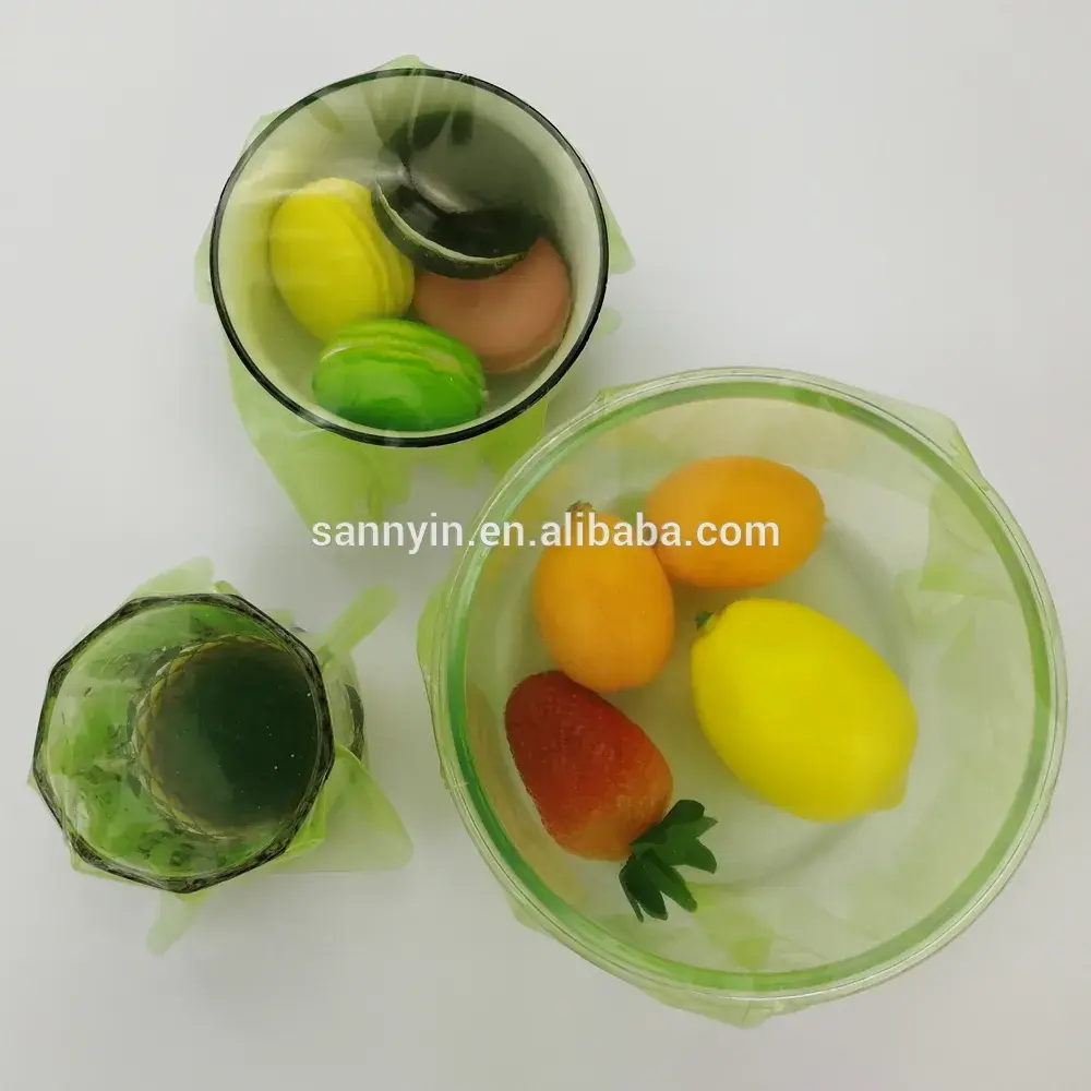 Reusable silicone cling film sealing a bowl of fresh fruit